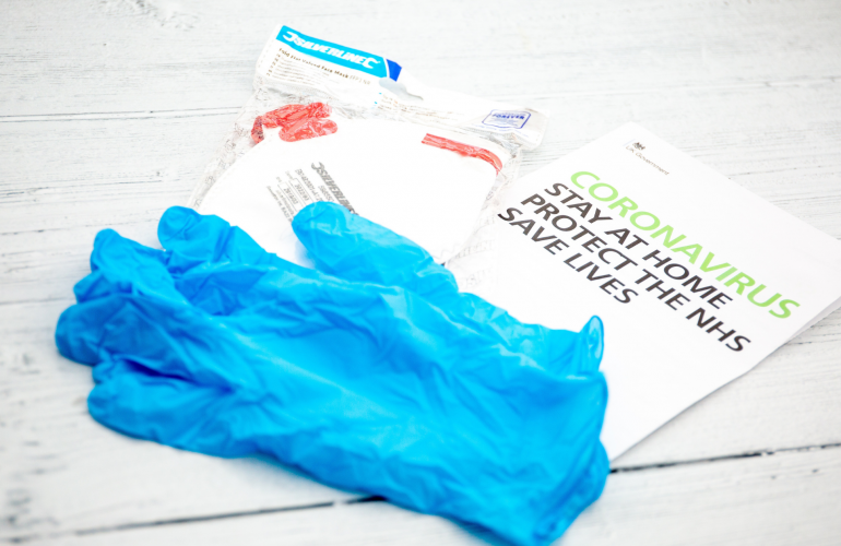 Disposable gloves and an NHS Coronavirus leaflet