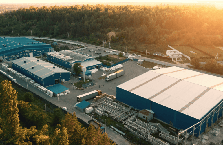 Sun rising over a factory