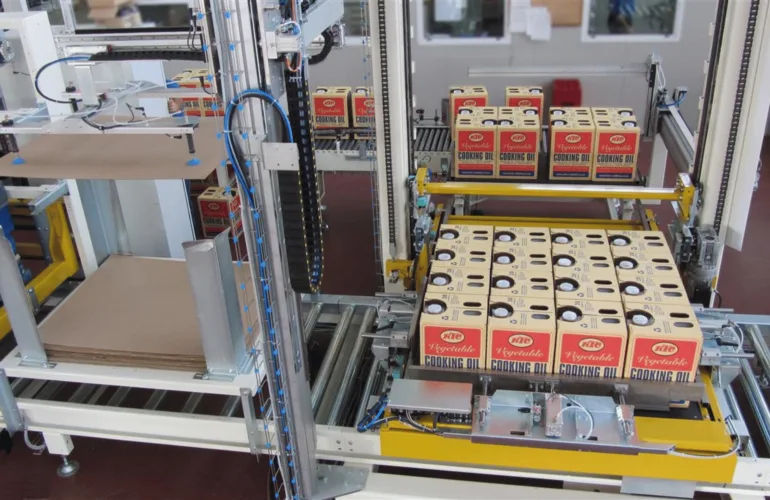 Lita tray handling machinery in action with cases of cooking oil