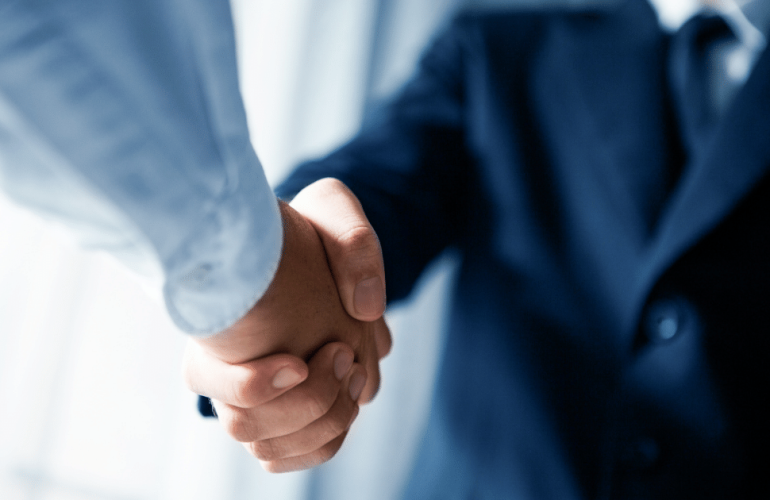 Businessmen in blue shake hands