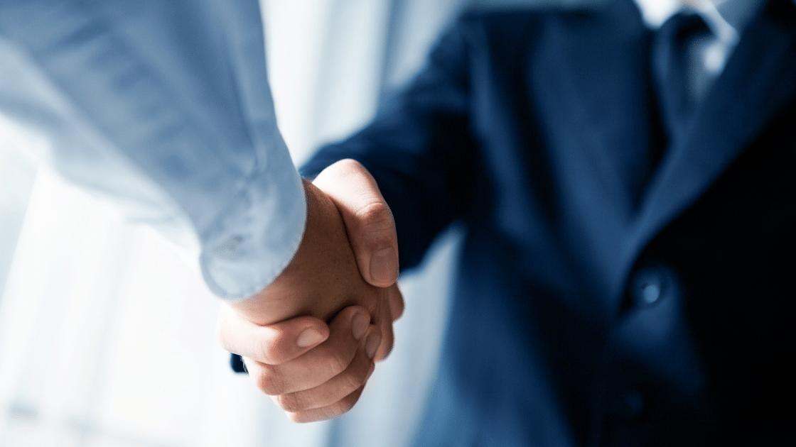 Businessmen in blue shake hands