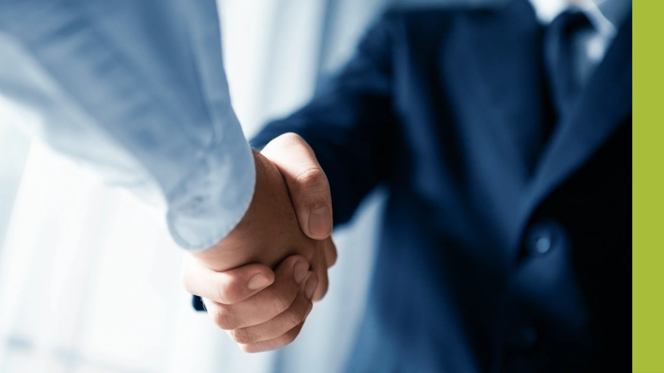 Businessmen in blue shake hands