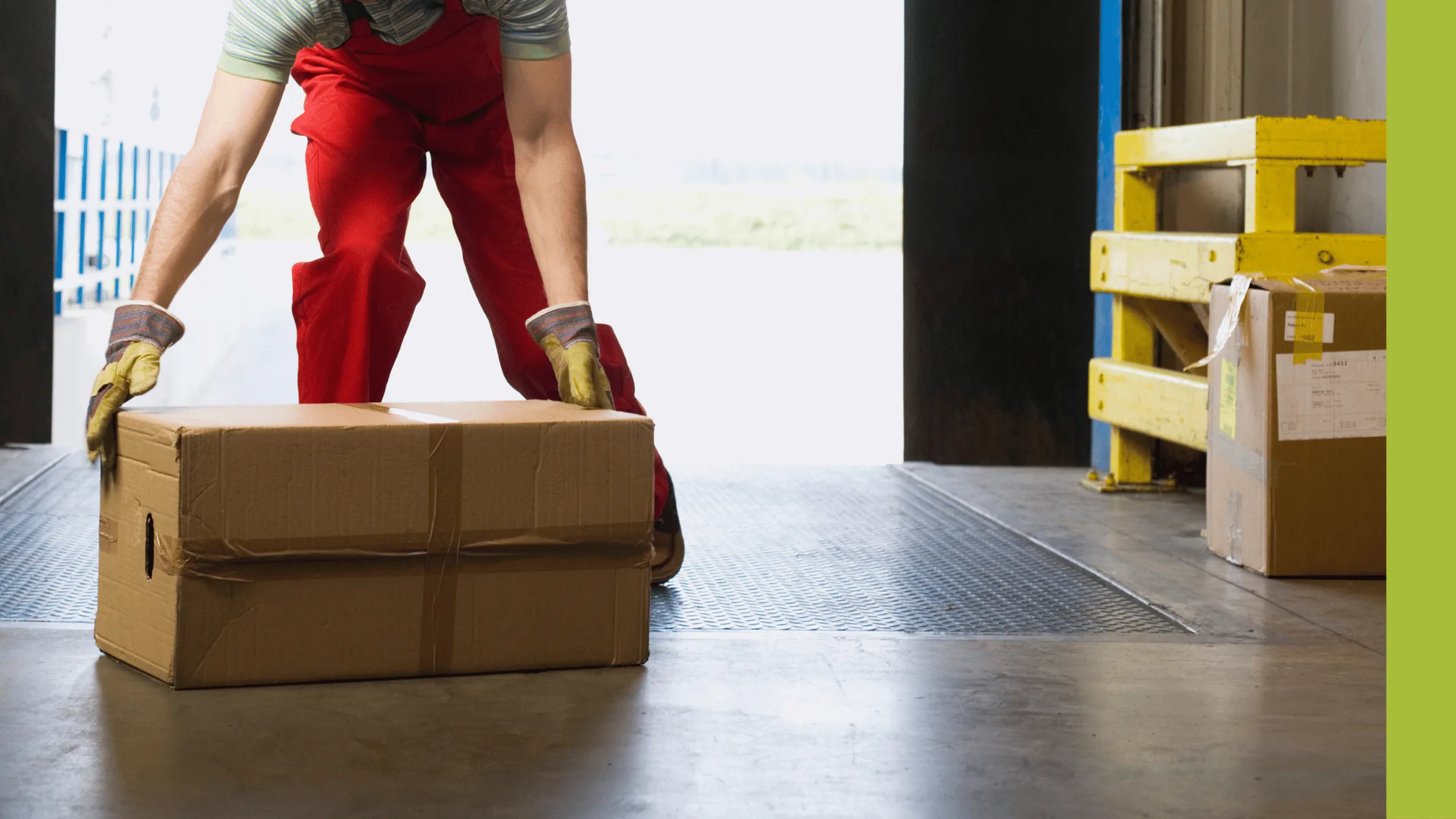Man manually lifting a box in a manufacturing environment