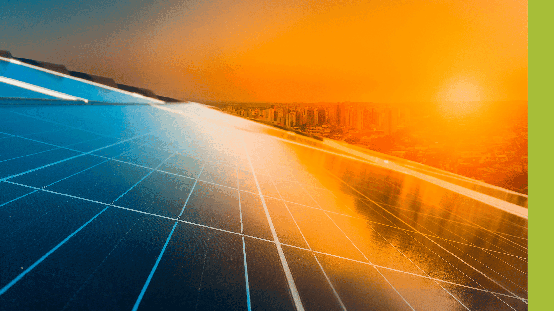 A view of a glass building with sunset on a city in the background