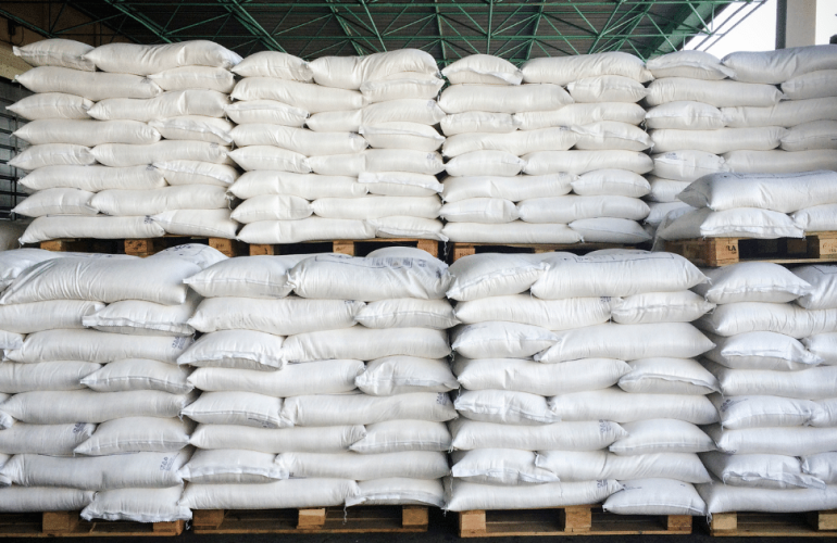 A pile of white sacks stacked neatly on pallets