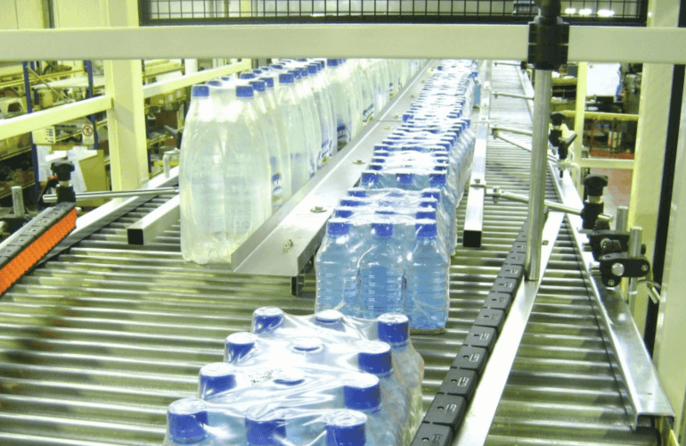 Water bottles passing through an automated conveyor