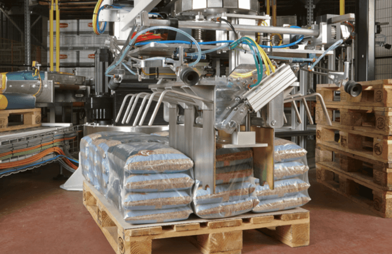 Europack palletiser lifting sacks onto a pallet in a production facility