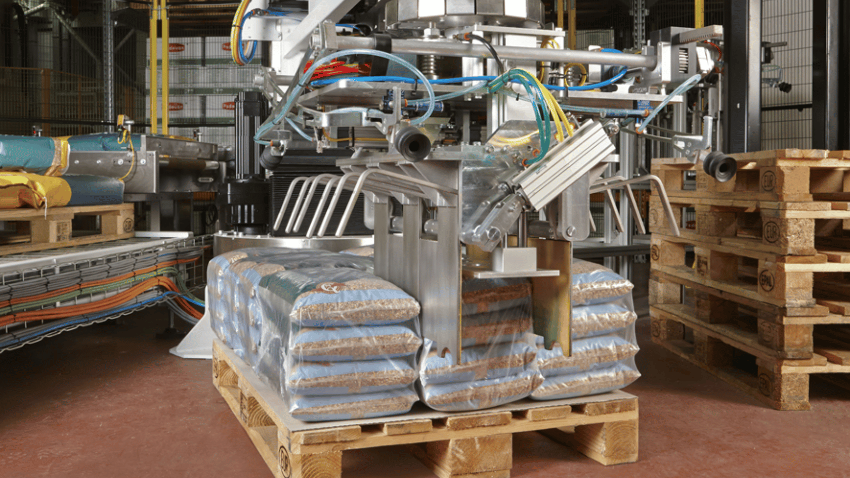 Europack palletiser lifting sacks onto a pallet in a production facility