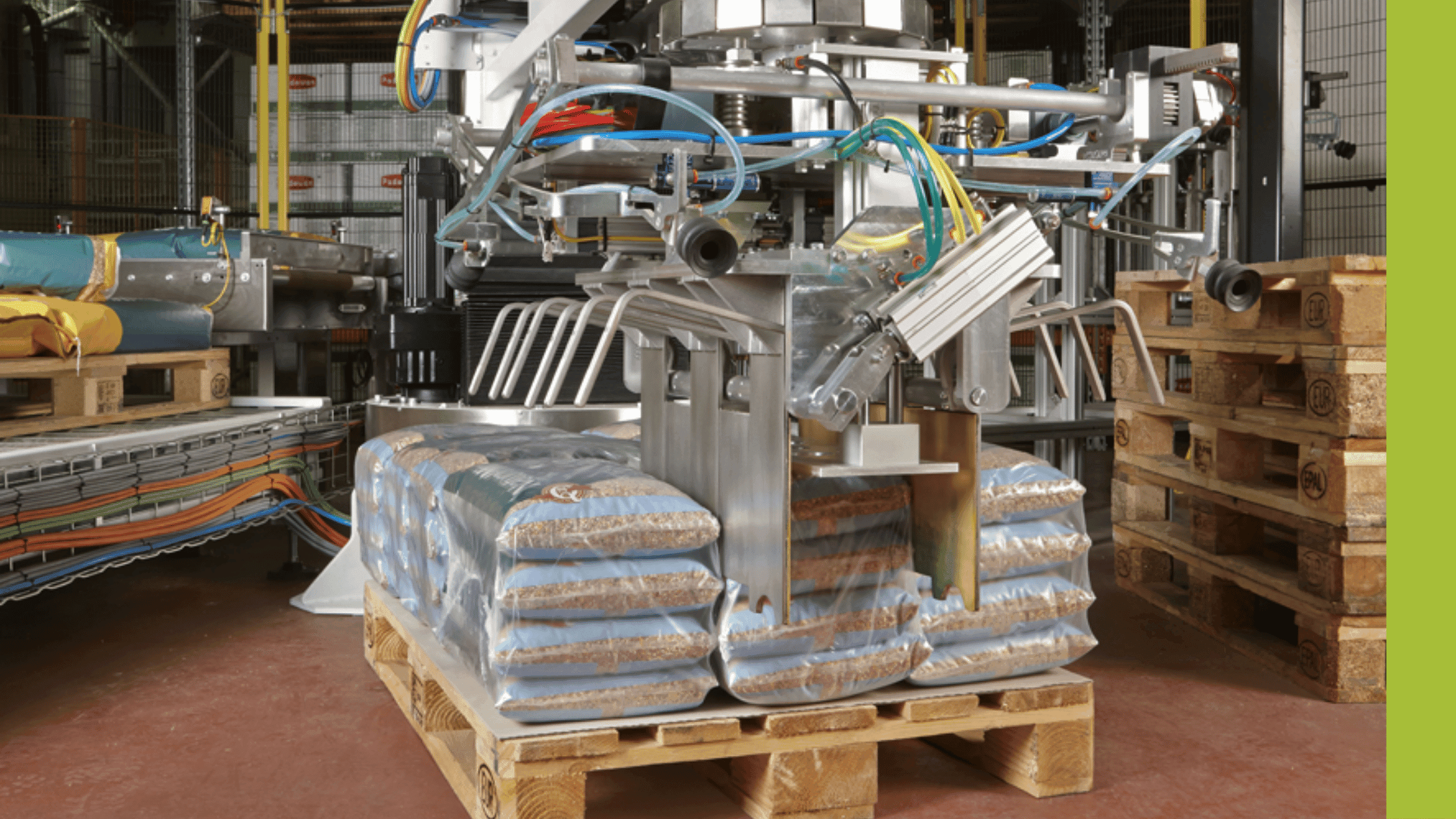 Europack palletiser lifting sacks onto a pallet in a production facility